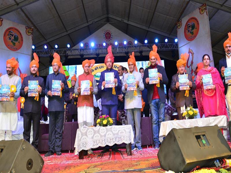 Chief Minister Jai Ram Thakur releasing a colourful souvenir on Swarnim International Shivratri Fair at Mandi today.